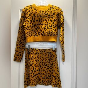 O. Vianca two-piece crop, animal print, long sleeve skirt set.